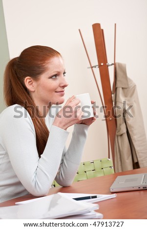 Young long red hair  business woman at office with coffee having break