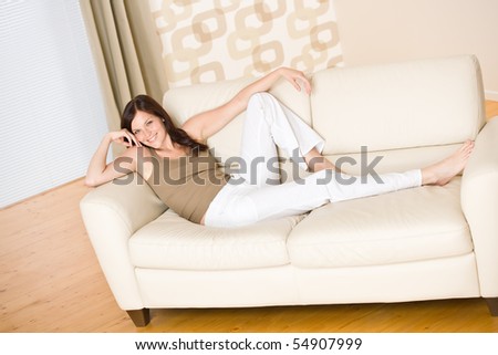 Smiling woman relax sitting on sofa in lounge