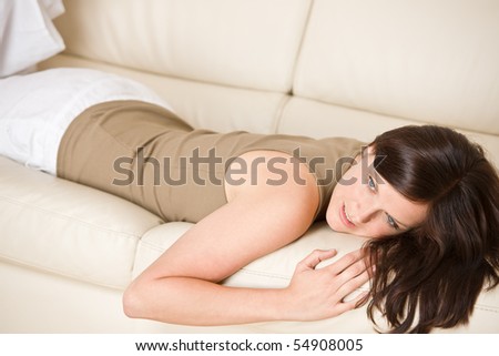 Young woman relax lying down on sofa in lounge