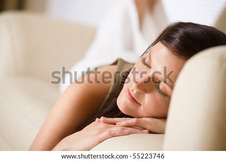 Beautiful woman sleeping on sofa in lounge