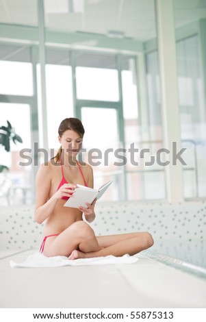 Swimming pool - woman relax with book sitting down