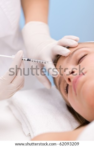 Woman in cosmetic medicine treatment getting an injection, close-up portrait