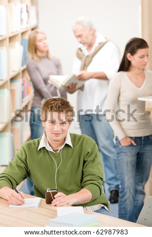 High school library - student with headphones listen to music