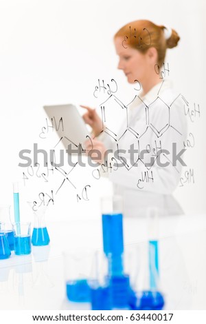Woman scientist in laboratory research with touch screen computer