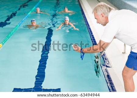 Swimming pool - swimmer training competition in class with coach