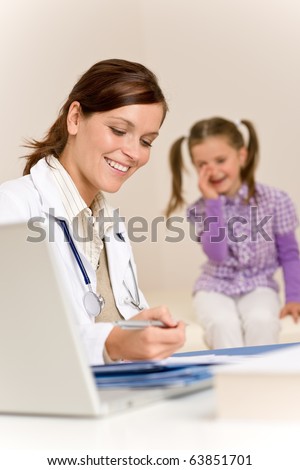 Female doctor write prescription for child at clinic