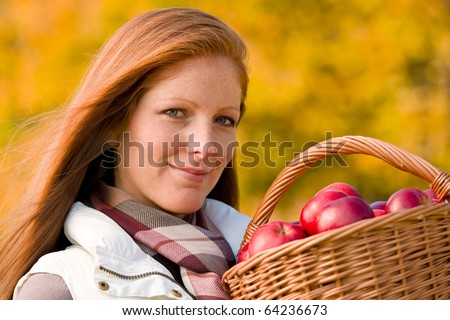 Autumn country - woman with wicker basket harvesting apple