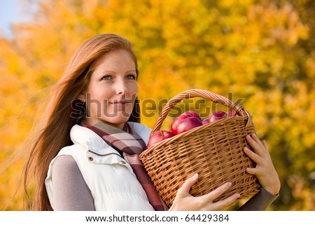 Autumn country - woman with wicker basket harvesting apple