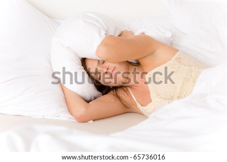 Bedroom - lazy woman getting up blocking ears
