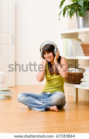 Teenager girl relax home - happy listen to music with headphones