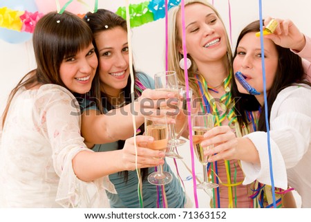 Birthday party celebration - four woman with confetti have fun, focus on glasses