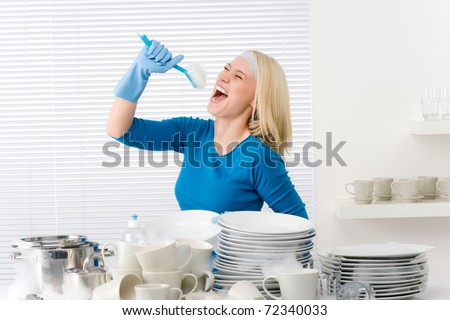 Modern kitchen - woman pretend to sing song with brush