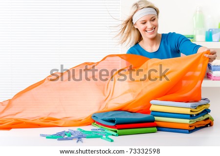 Laundry - woman folding clothes, housework