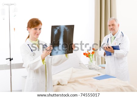 Medical team - portrait of two doctor with x-ray in hospital