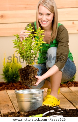 Gardening woman hold flowerpot plant spring terrace