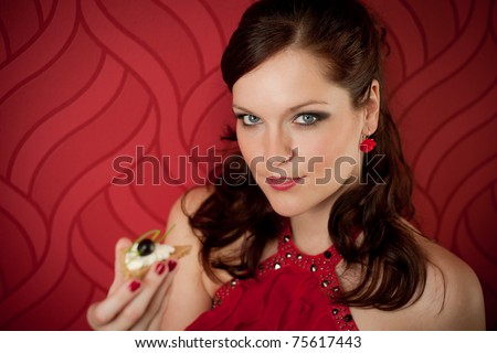 Cocktail party woman eat appetizer evening dress red background