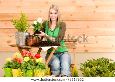 Gardening woman hold flowerpot plant spring terrace