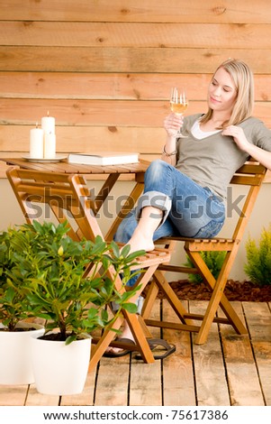Garden happy woman enjoy glass wine sitting on terrace