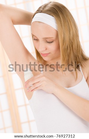 Beauty body care teenager woman apply deodorant in bathroom