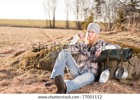 Camping young woman in countryside hiking with backpack relax