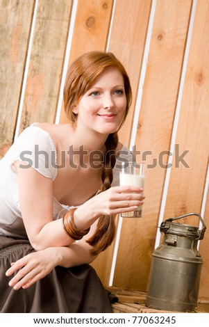 Young woman drink healthy natural home-made milk in barn