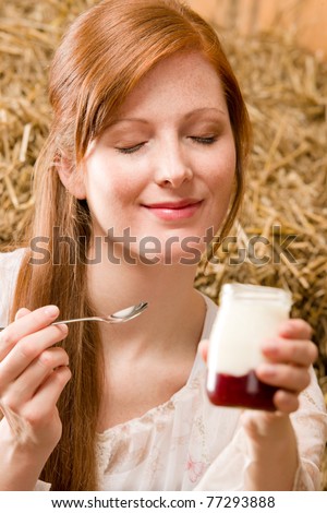 Young romantic woman with natural home-made yogurt in barn