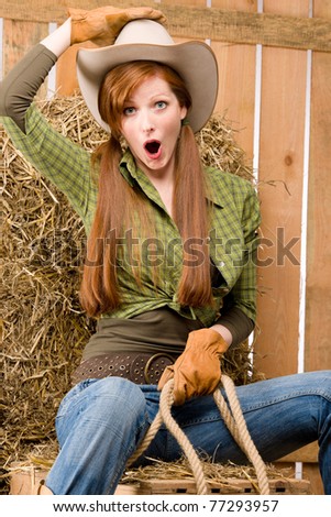 Crazy young cowgirl horse-riding country style in barn