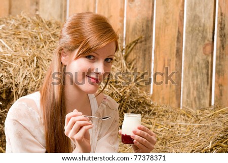Young romantic woman with natural home-made yogurt in barn