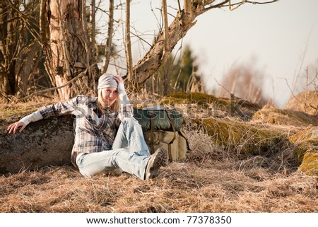 Camping young woman in countryside hiking with backpack relax