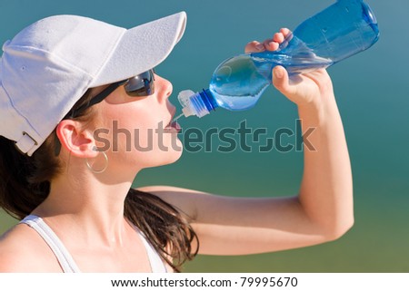 Summer active woman drink water bottle in fitness outfit