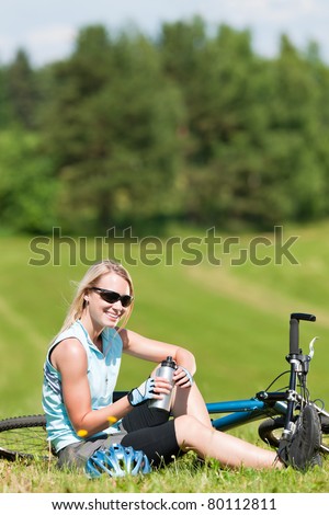 Sport mountain biking happy girl relax in meadows sunny countryside