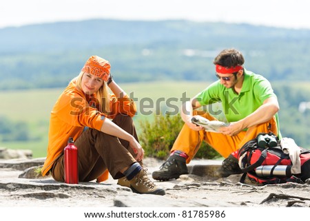 Young backpack couple with hiking poles beautiful panoramic view countryside