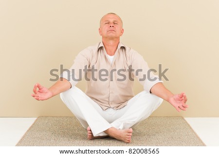 Casual business yoga senior handsome businessman stress control lotus pose