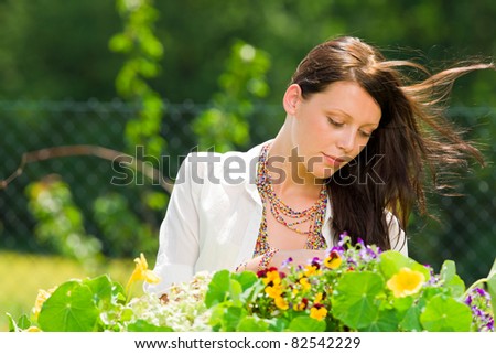 Summer garden beautiful young romantic woman with colorful flower portrait