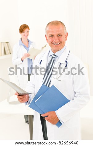 Medical doctor team senior man with female nurse hold x-ray