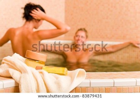 Spa and beauty products two naked women inside pool water beauty health
