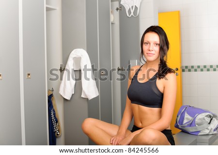 Locker room young sportive woman sitting smiling fitness training