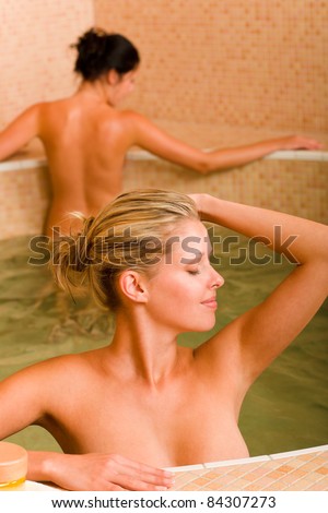 Spa beauty relax pool two naked women inside water healthy