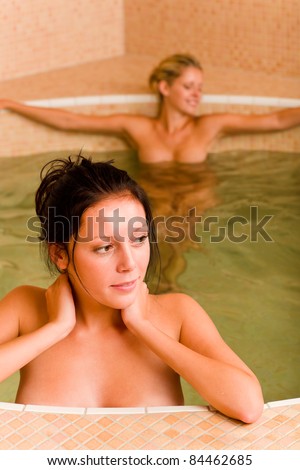 Relax spa pool two naked women inside water beauty health