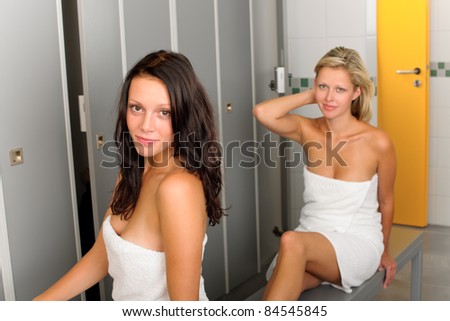 Locker room two relaxed women attractive wrapped in white towel