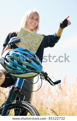 Close-up of helmet mountain biking young woman search in map