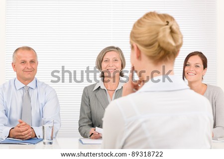 Business interview young woman being examined by professional manager team