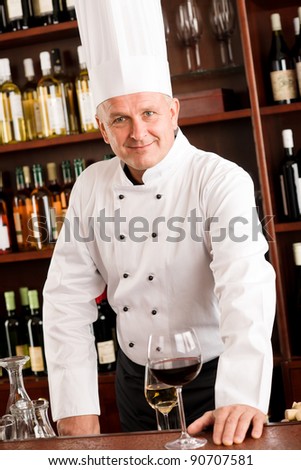 At the bar - senior barman chef standing wine degustation