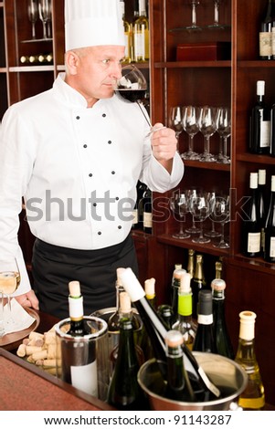 Chef cook taste glass of red wine in restaurant bar