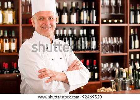 Chef cook confident professional posing in restaurant cross arms