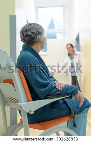 Senior patient in hospital waiting for doctor sitting in wheelchair