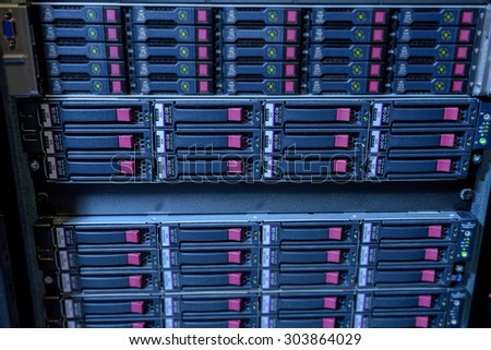Rack of webserver harddisks in datacenter showing internet traffic