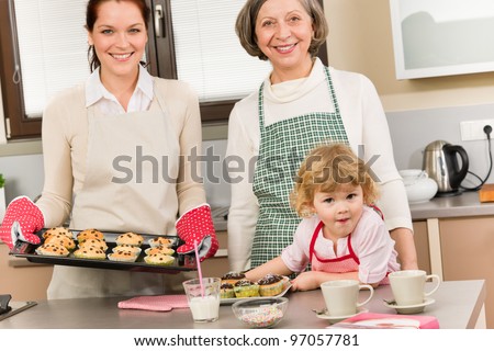 Family women baking cupcakes in kitchen grandmother, mother and granddaughter