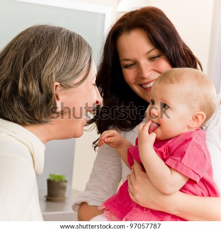 Happy family women - grandmother, mother and baby make funny face