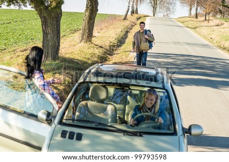Young man road trip girl friends offer lift with car